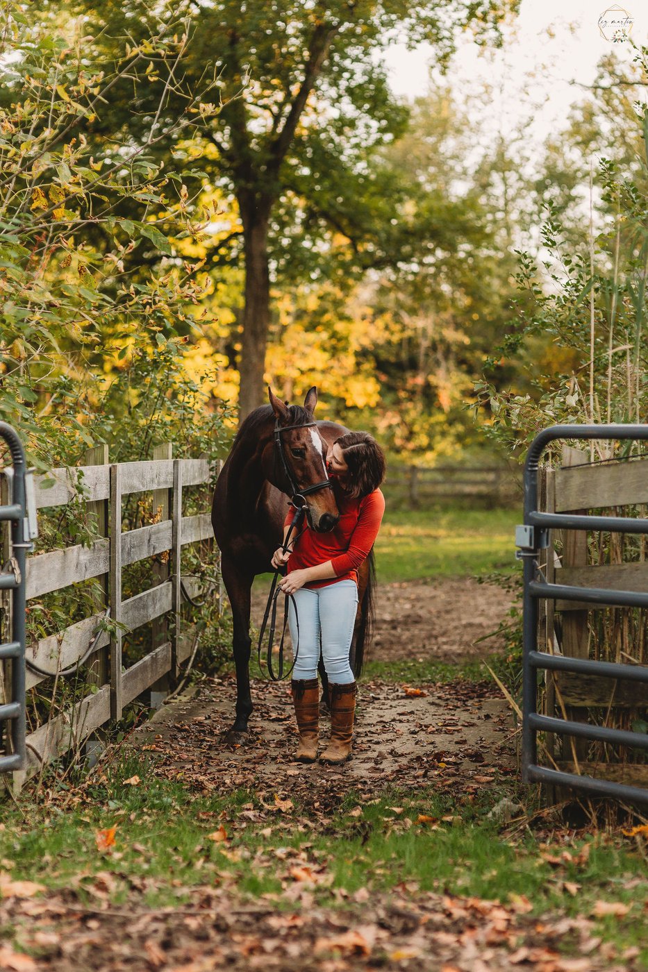 Sonja sharing a quiet moment with Luna, her bay mare, among fall colors